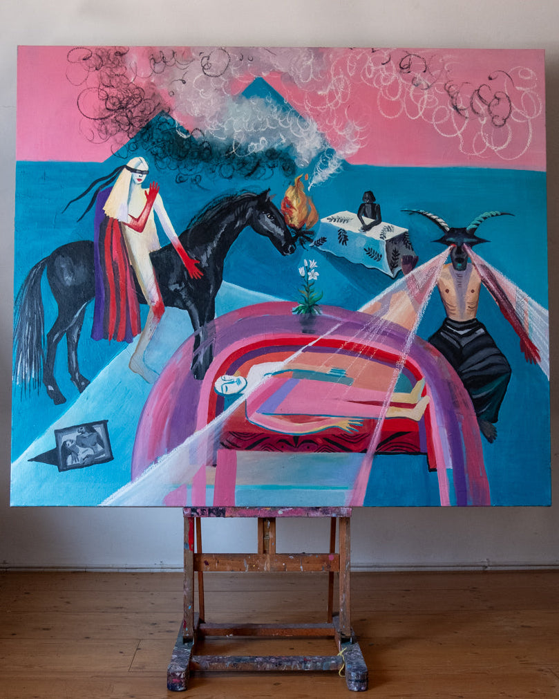 Colorful abstract painting on an easel against a white wall.