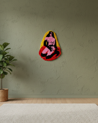 Colorful abstract wall art on a green wall with a plant and rug in the foreground